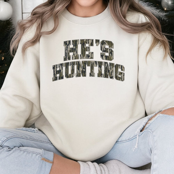 He's Hunting Sweatshirt | Camo Collegiate Lettering Design | Premium Cotton-Poly Blend | Gift for Deer Hunters and Outdoorsme